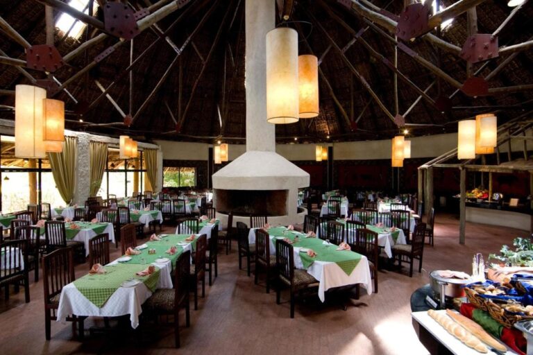 La salle du restaurant autour de sa cheminée centrale, avec le buffet sur la droite